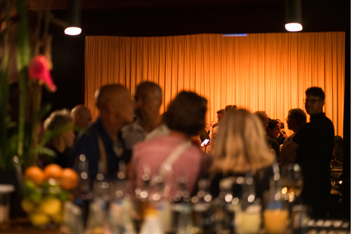 After-show get-together: guests are mingling at the bar and the theatre hall